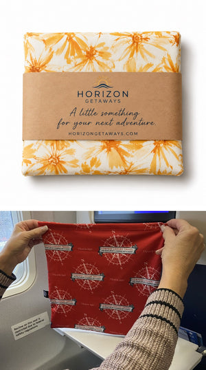 Go-Be branded Kraft wrap sleeve stacked above a custom Compass sleeve on a tray
